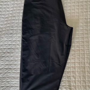 lulu lemon yoga cropped pants in black with mesh pinstripe detail.